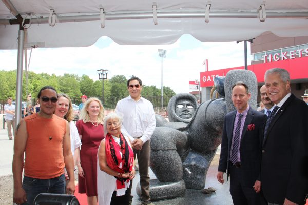 Ahqahizu, a monumental sculpture of an Inuit soccer player embellished with silver eyes and holding a bronze walrus skull for a ball was unveiled today at York Lions Stadium. From left, Inuit sculptor Ruben Komangapik; project lead and York U Professor Anna Hudson; Rhonda Lenton, Vice-President and Academic Provost; Native women’s rights activist Jeannette Corbiere; Inuit artist Koomuatuk (Kuzy) Curley; Shawn Brixey, Dean, School of Arts, Media Performance & Design (AMPD); Gary Brewer Vice-President, Finance and Administration (partially seen); and Mamdouh Shoukri, President and Vice-Chancellor, York University