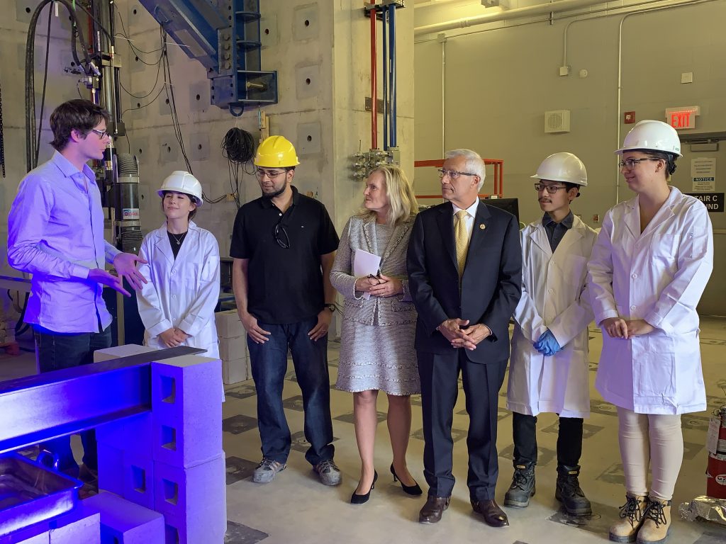 Ontario MPP Victor Fedeli watches as Lassonde School of Engineering Professor John Gales demonstrates fire testing during a visit to York University's High Bay Structure Lab for an Ontario Government research funding announcement. 