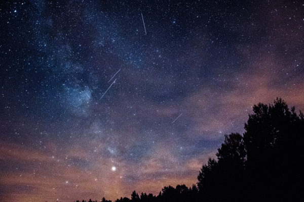 meteors streaking across a night sky