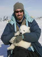 Prof Greg Thiemann holding a baby polar bear