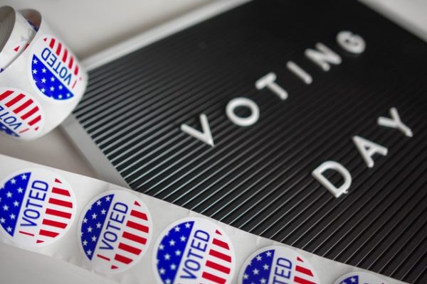 Image of ballots and voting day message